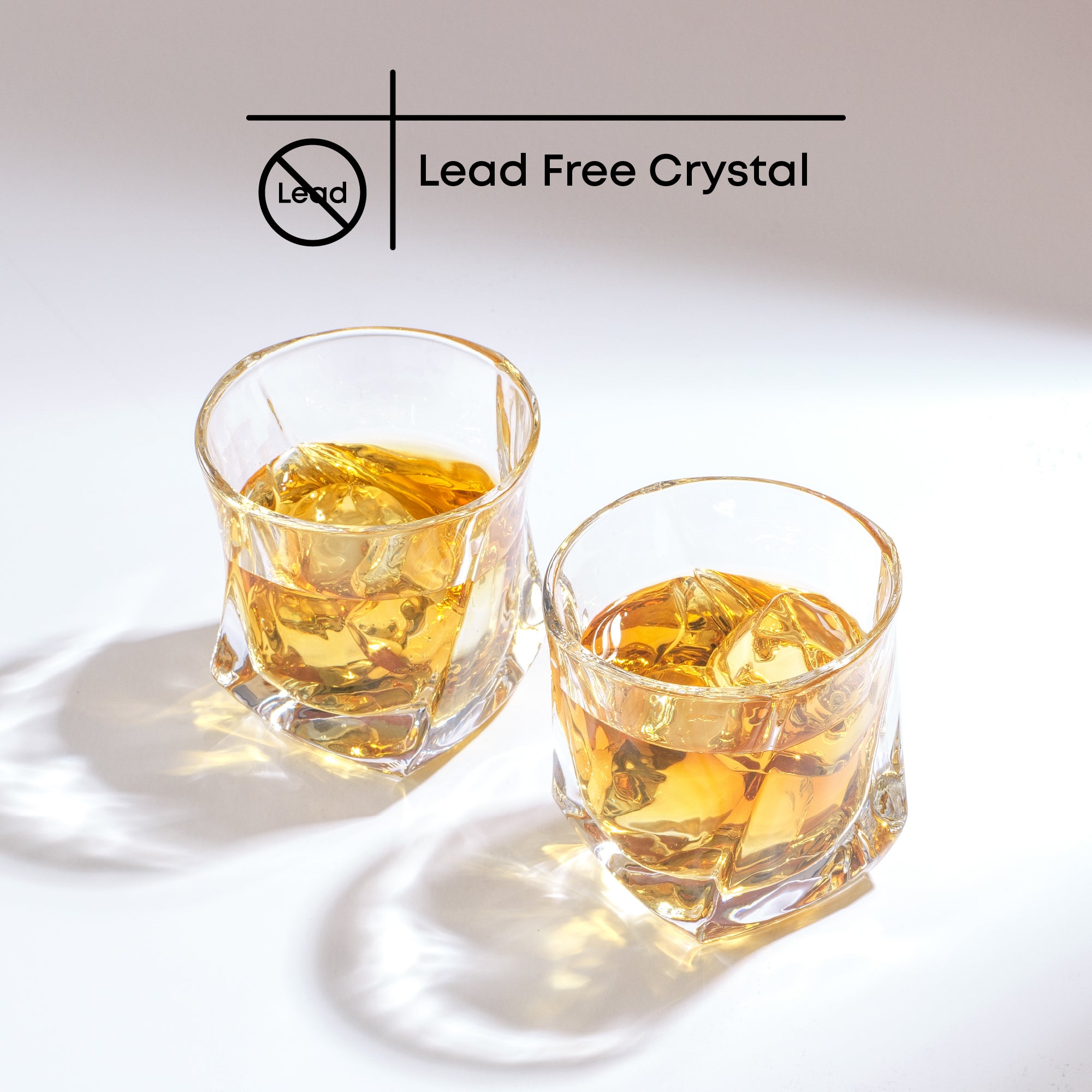 Two Aurora Whiskey glasses filled with whiskey and ice. Text on image reads, “Lead Free Crystal.”