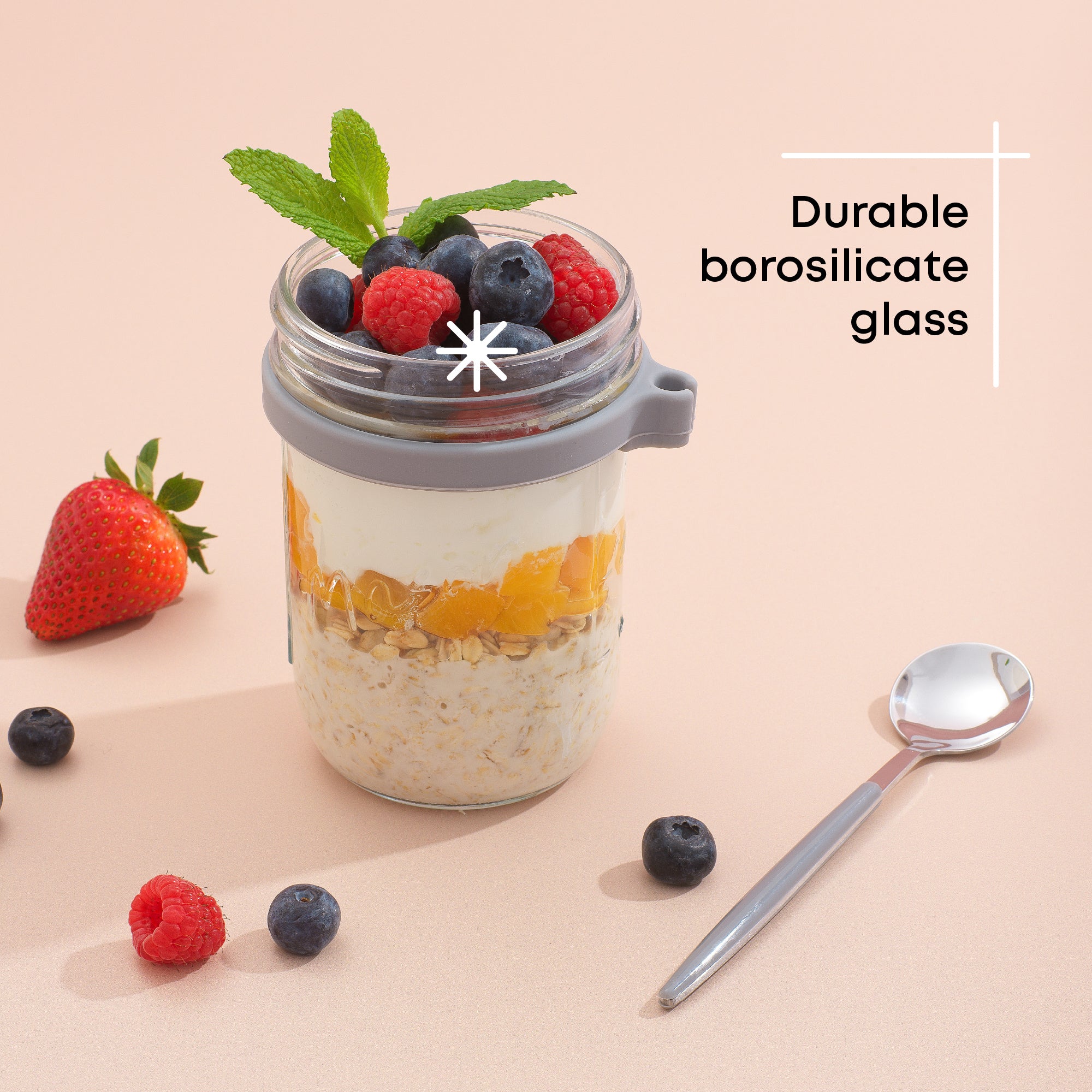 Durable borosilicate glass grey overnight oats container filled with fruit and yogurt.