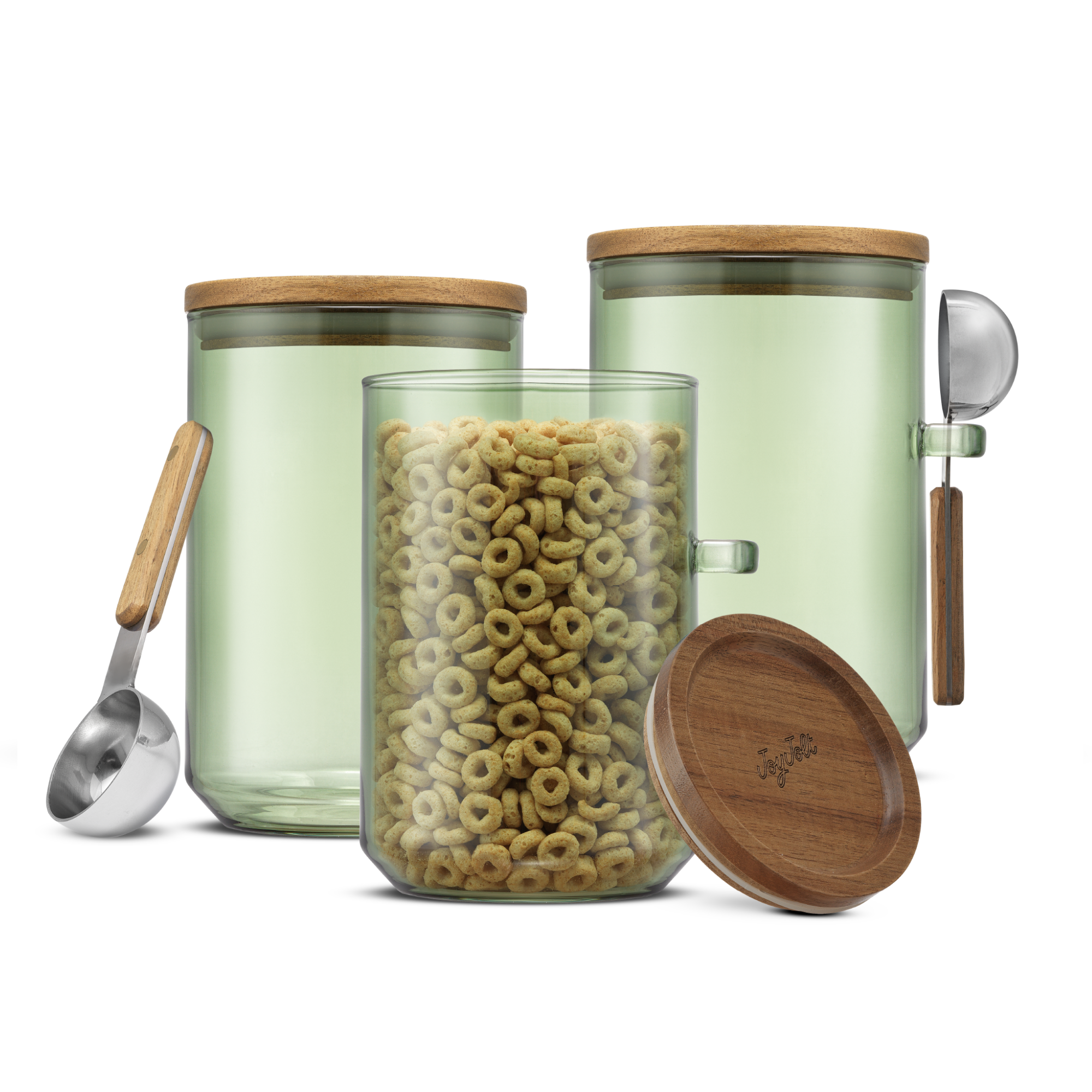Sage colored glass storage canisters with wooden lid and spoon, filled with cereal on a white background.