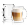 Two clear double wall glass mugs with handles, one filled with a layered coffee drink on a white background.