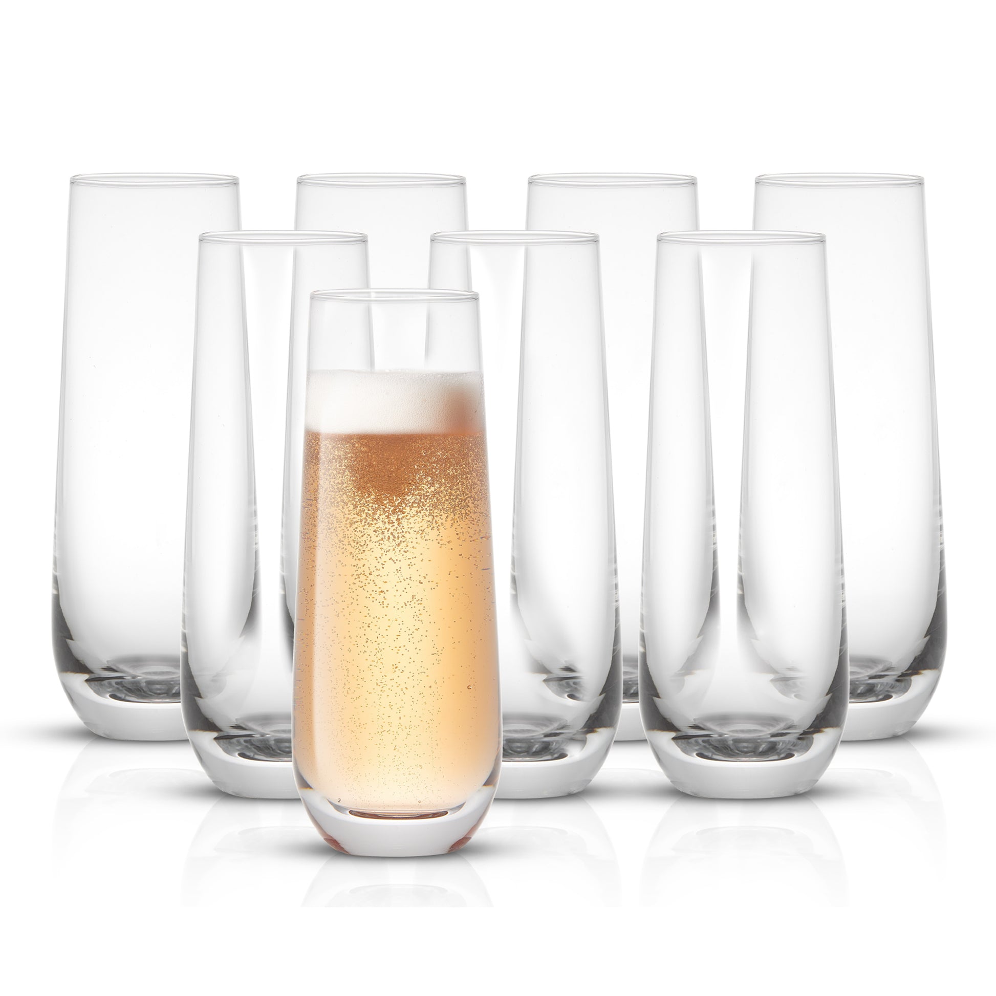 A set of 8 stemless champagne glasses. One glass is filled with champagne. 