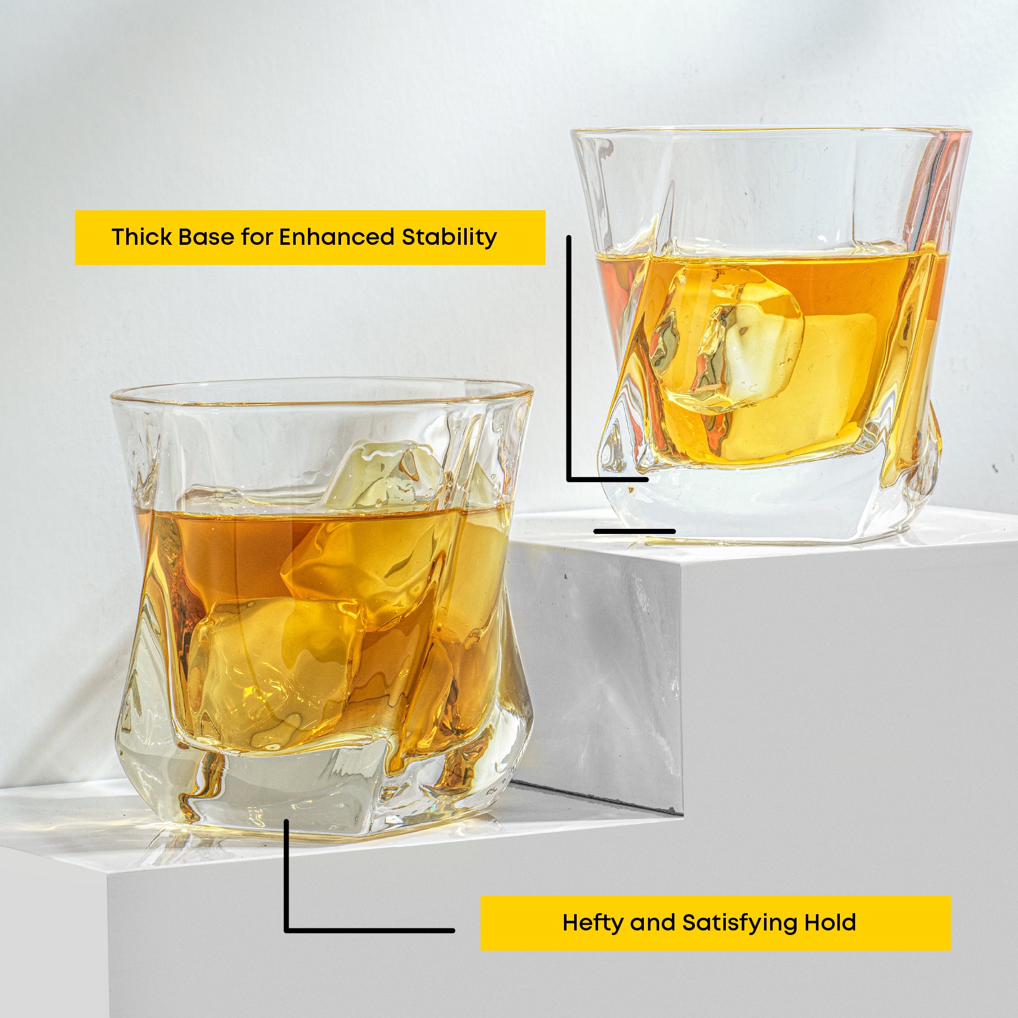 Two whiskey glasses on a platform. Text on the image reads, “Thick Base for Enhanced Stability” and “Hefty and Satisfying Hold.”