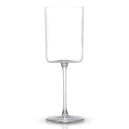 an empty clear wine glass against a white background