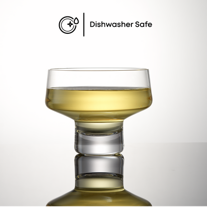 A stemless coupe glass with a yellow liquid inside and 'Dishwasher Safe' text on a white background