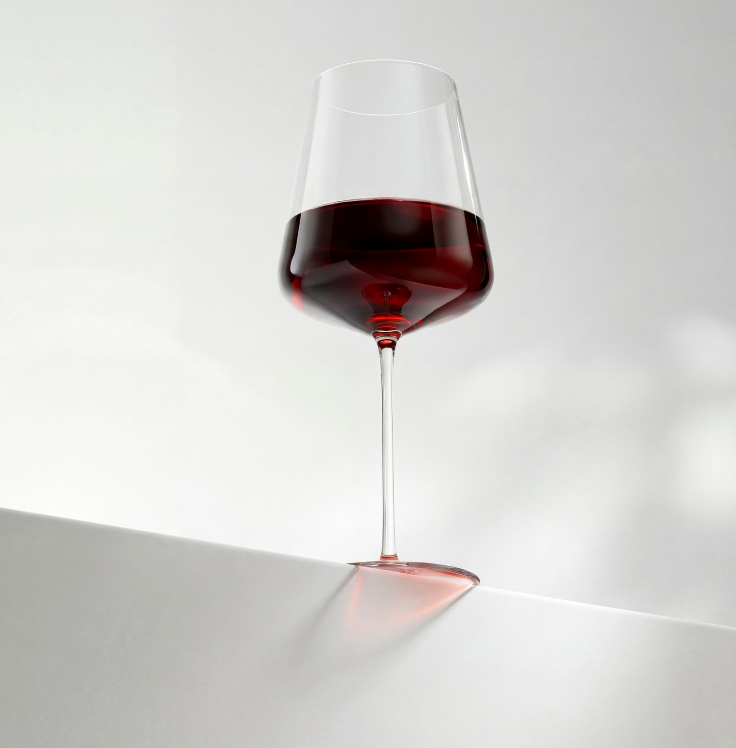 Wine glass with red wine on a white background
