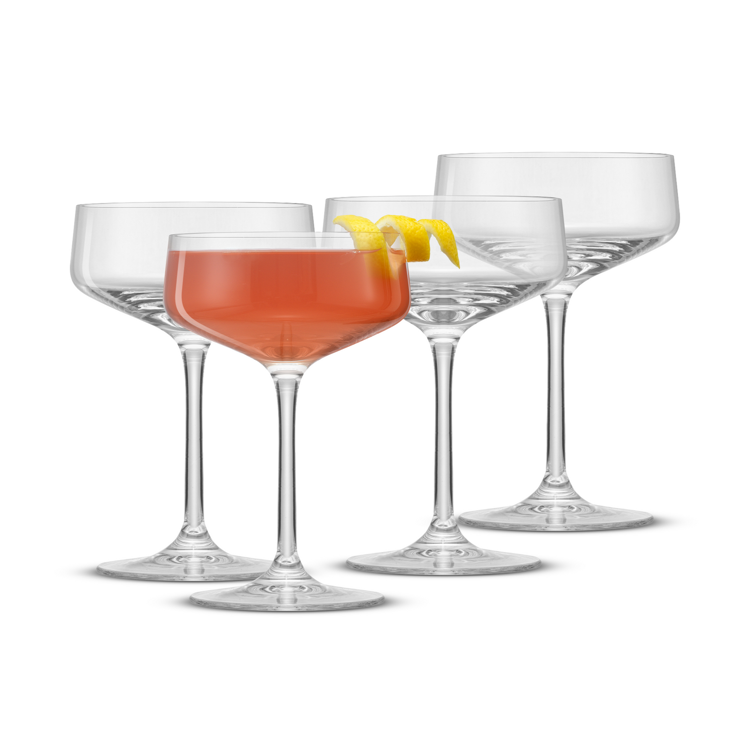 Set of four coupe glasses with a drink and lemon garnish on a white background