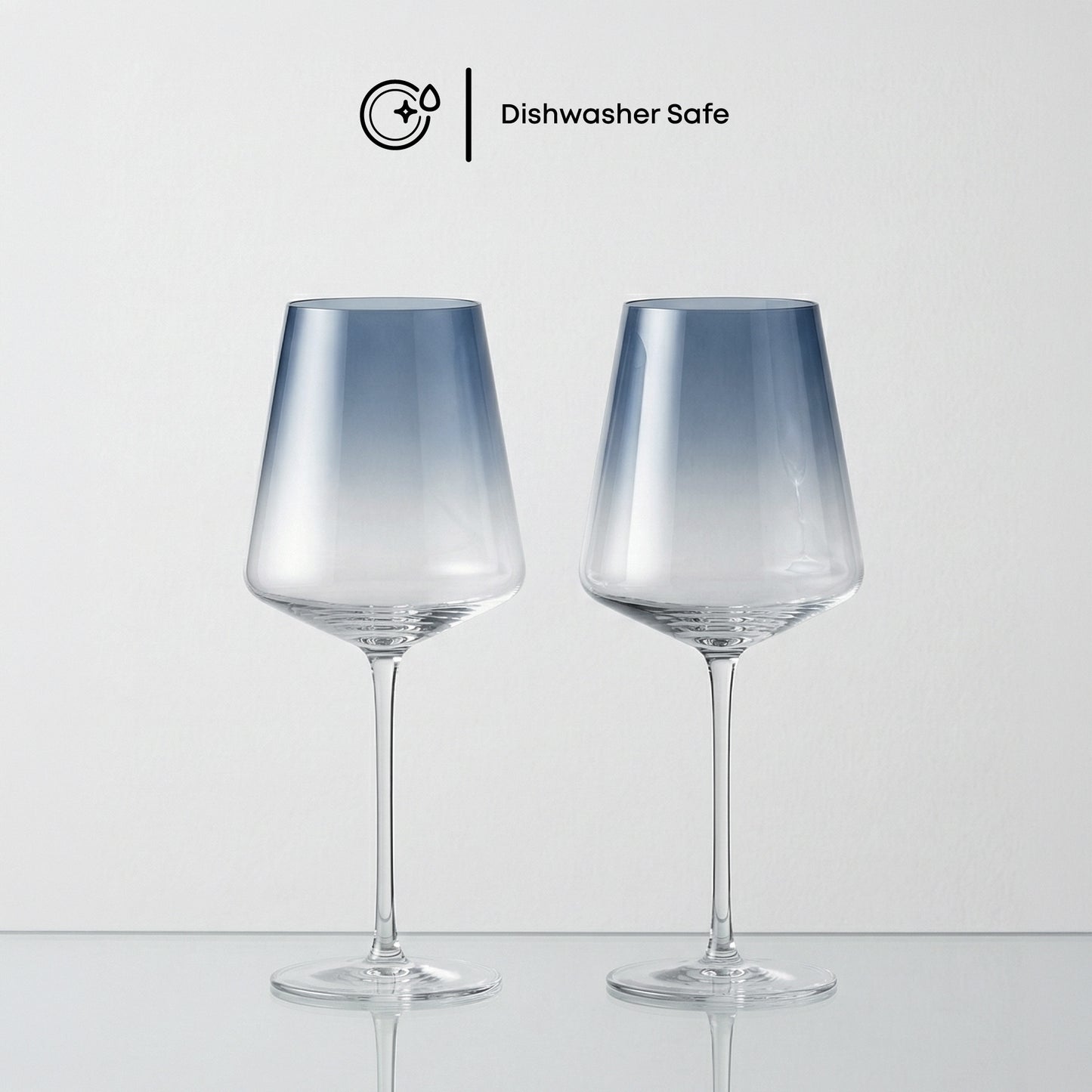 Two dishwasher-safe glass wine glasses on a light gray background