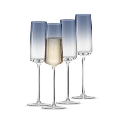 Set of four gradient blue champagne flutes on a white background