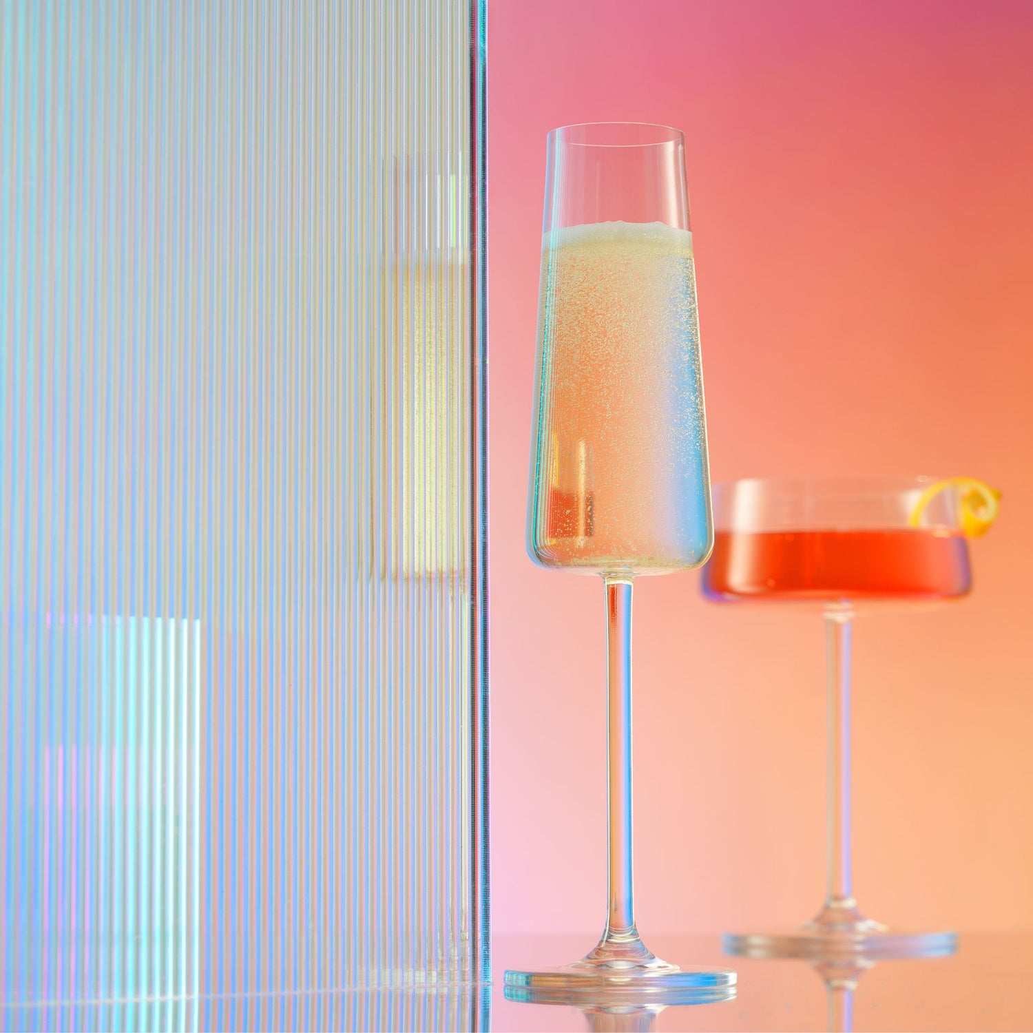 A glass of champagne with a colorful, blurred background