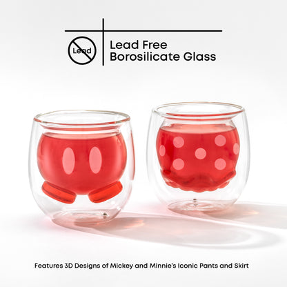 Two glass cups with a 3D double wall design featuring Mickeys pants and Minnies skirt, filled with a pink drink on a white background with text "lead free borosilicate glass"