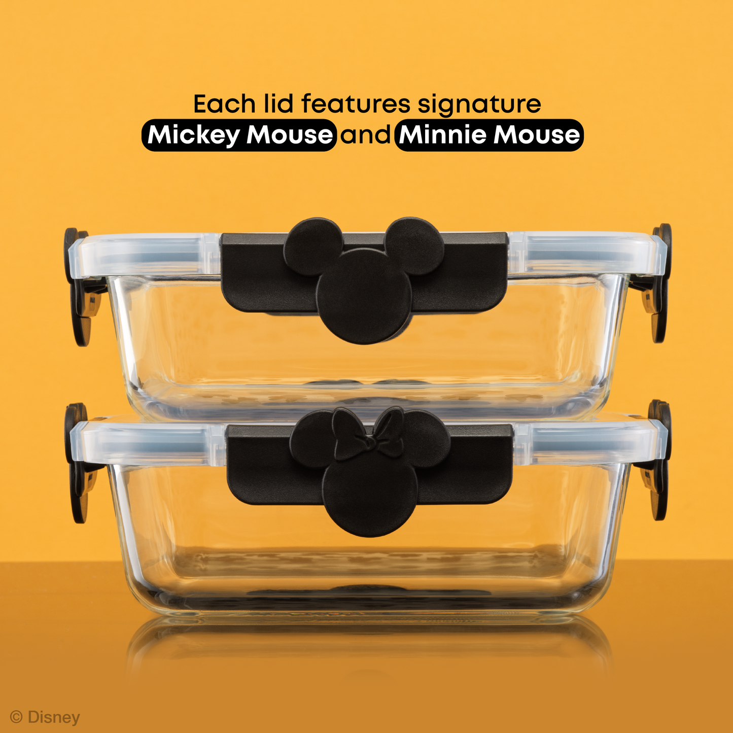 Two glass food containers stacked with Mickey Mouse and Minnie Mouse ears on the hinge clips
