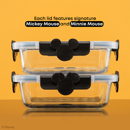 Two glass food containers stacked with Mickey Mouse and Minnie Mouse ears on the hinge clips