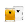 Two clear lowball glasses with black Mickey Mouse head details, one filled with an orange drink and ice, and one empty, shown on a white background.