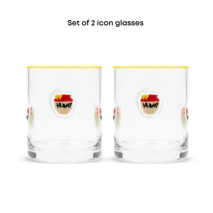 Set of 2 clear glass tumblers with a yellow rim, featuring a cartoon honey pot illustration on the front with the text 'HUNNY' and the caption 'Set of 2 icon glasses' above.