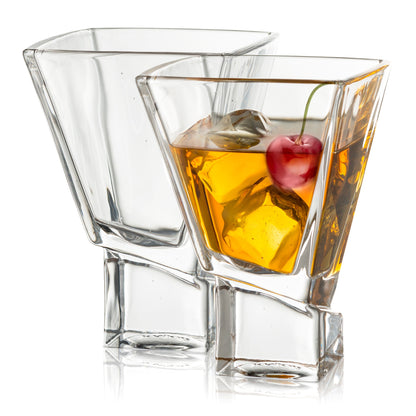 Clear glass with a cocktail and cherry on a white background