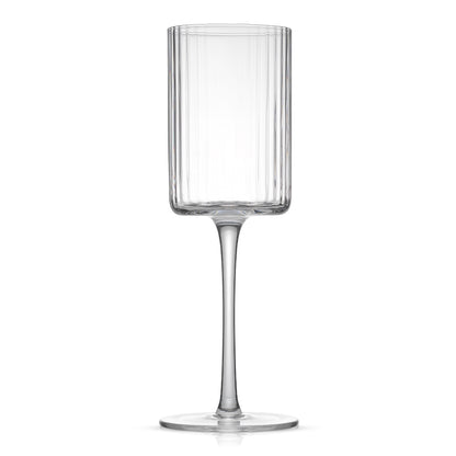 A tall, stemmed wine glass with a fluted cylindrical body and a single stem. 