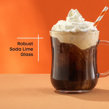 Glass of iced coffee with whipped cream and a straw on an orange background