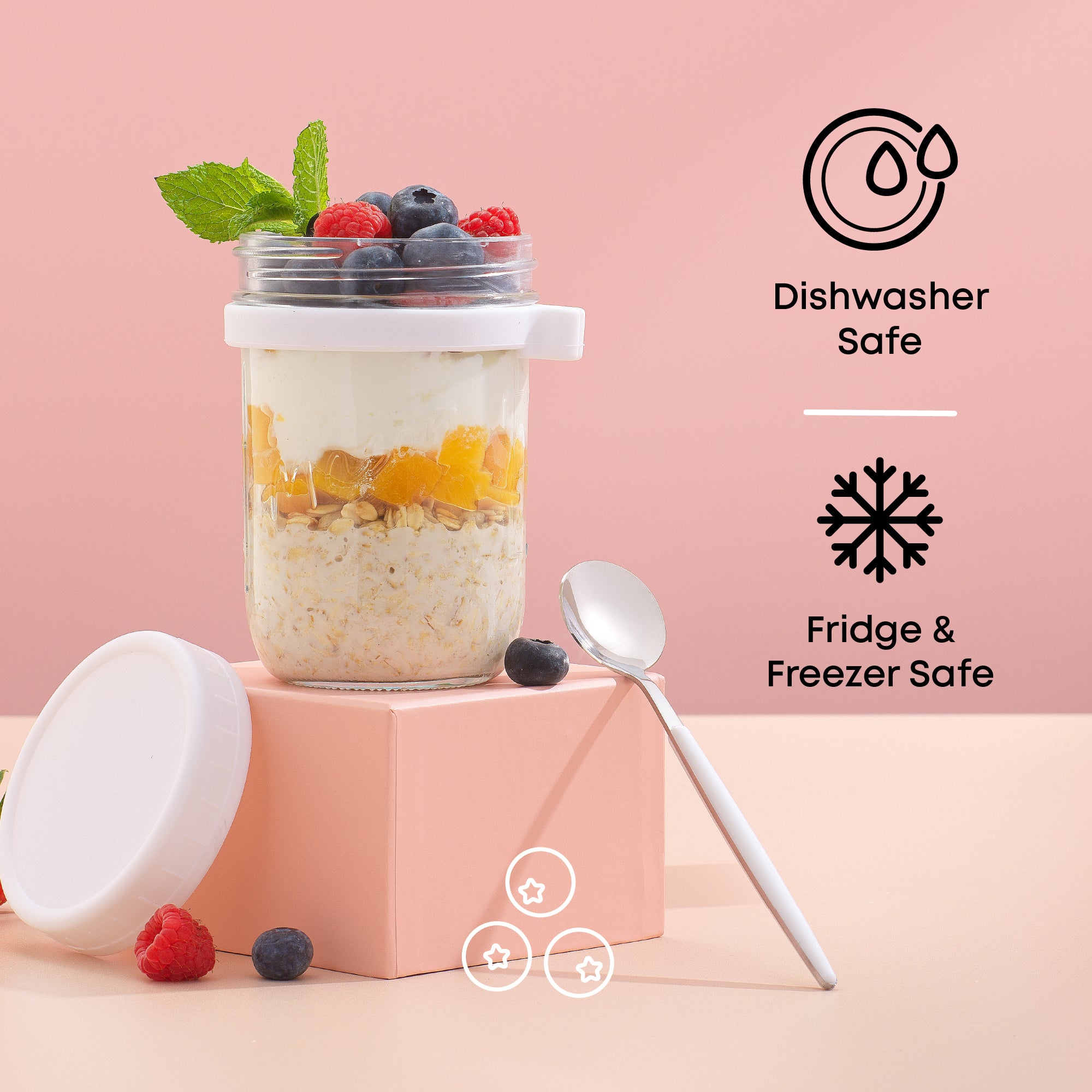 Overnight oats container filled with fruit and granola on a pink backdrop. 