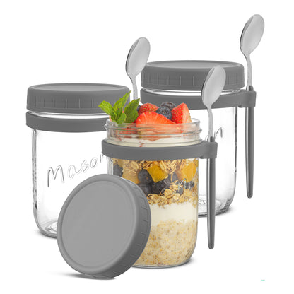 Three JoyJolt grey overnight oats container with spoons. 