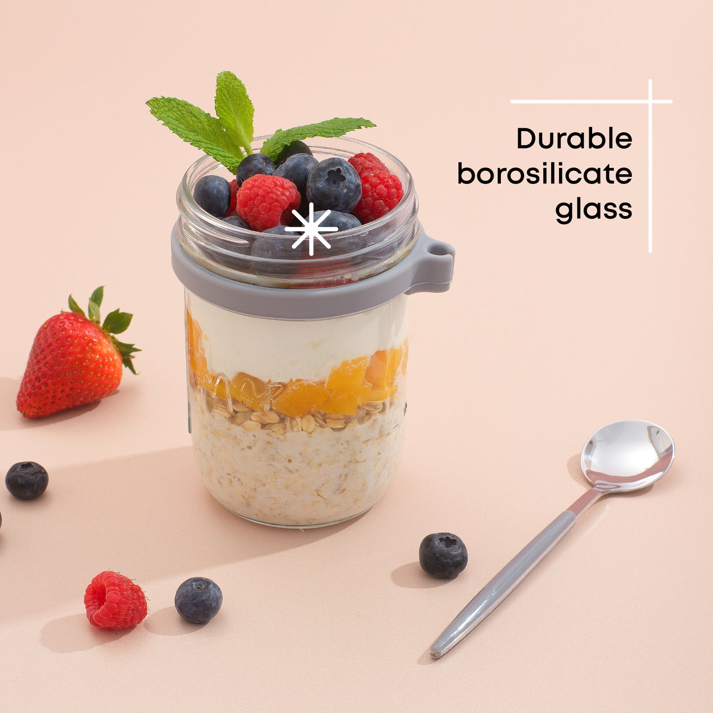 Durable borosilicate glass grey overnight oats container filled with fruit and yogurt. 
