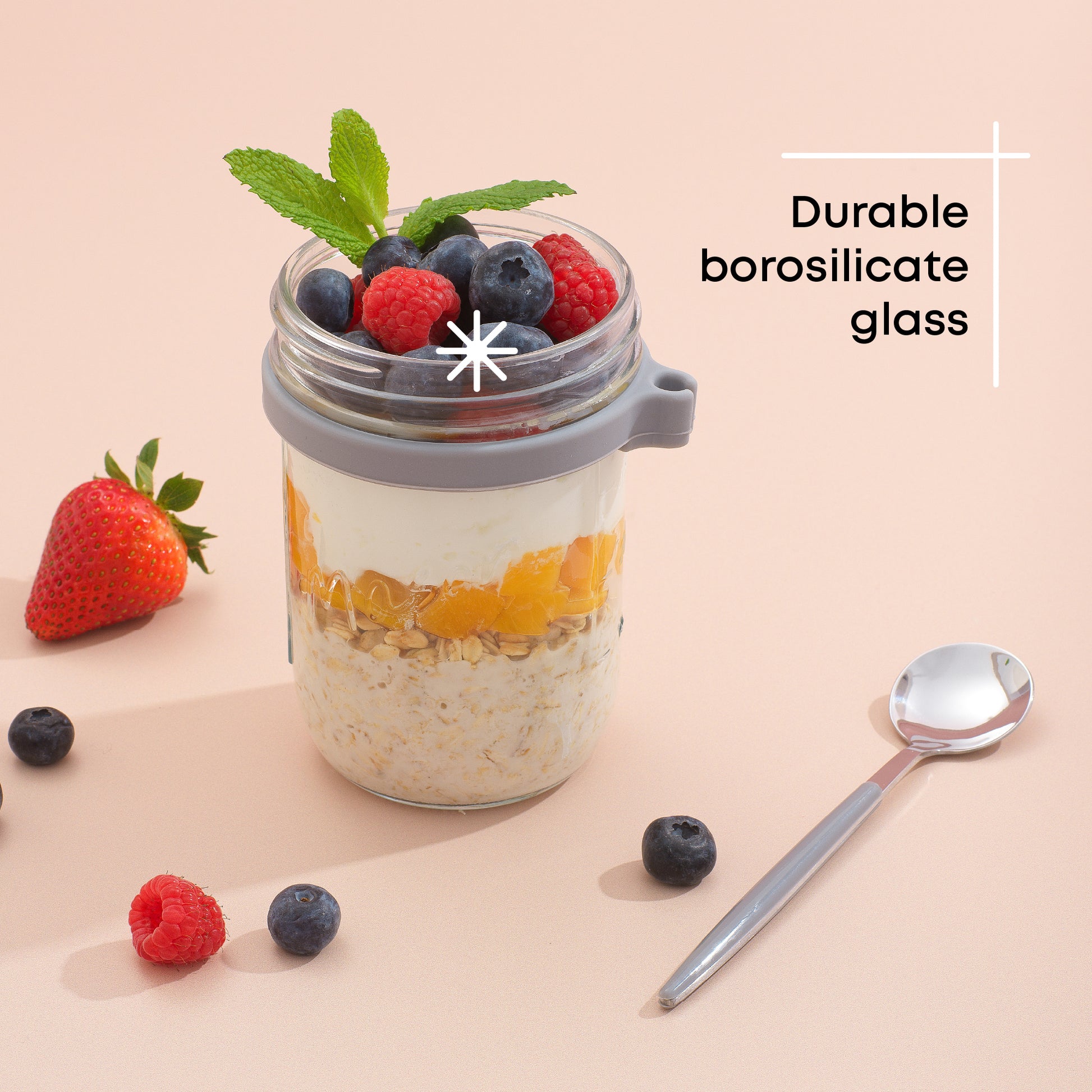 Durable borosilicate glass grey overnight oats container filled with fruit and yogurt. 
