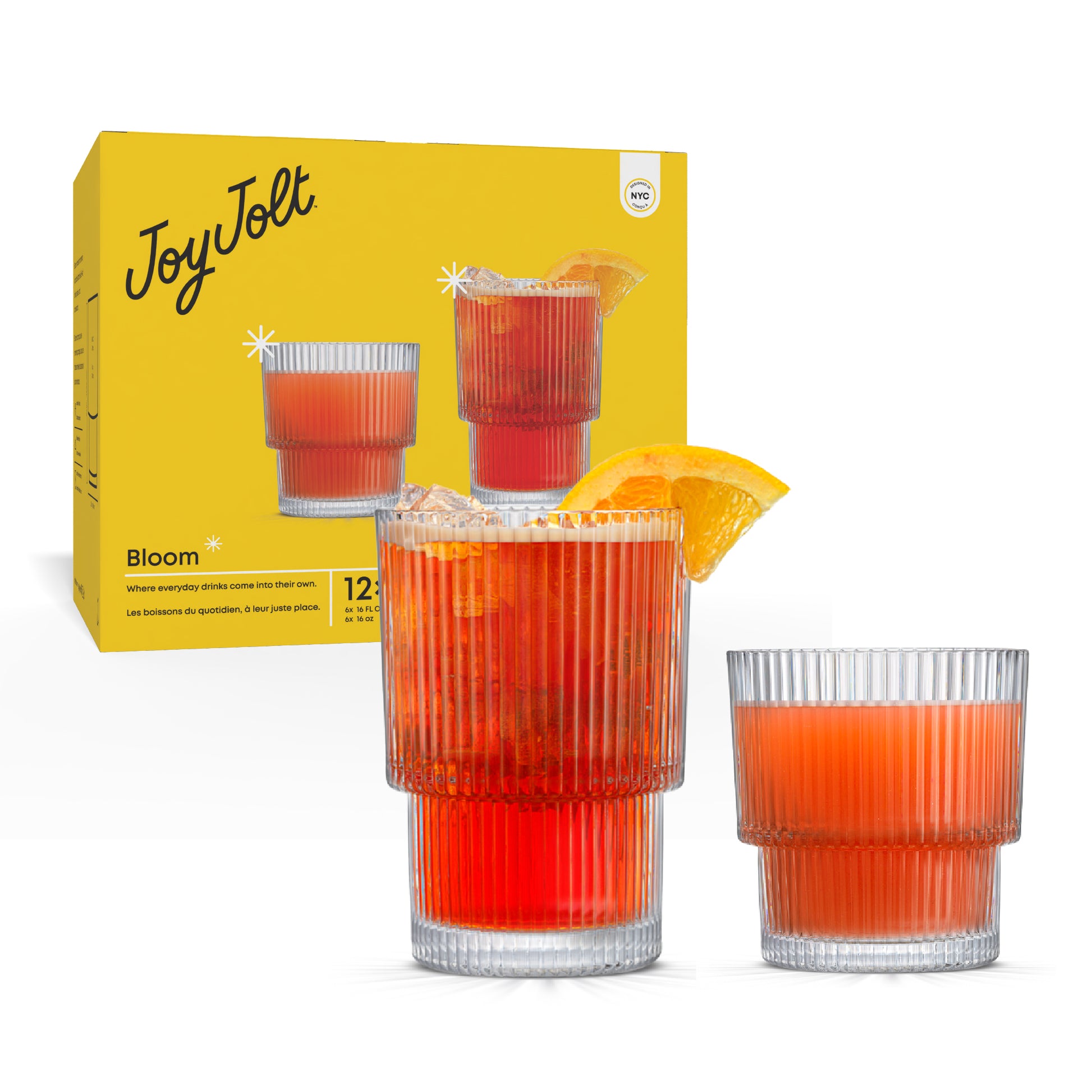 Two glasses of red juice with orange slices next to a yellow 'Joy Jolt' box.