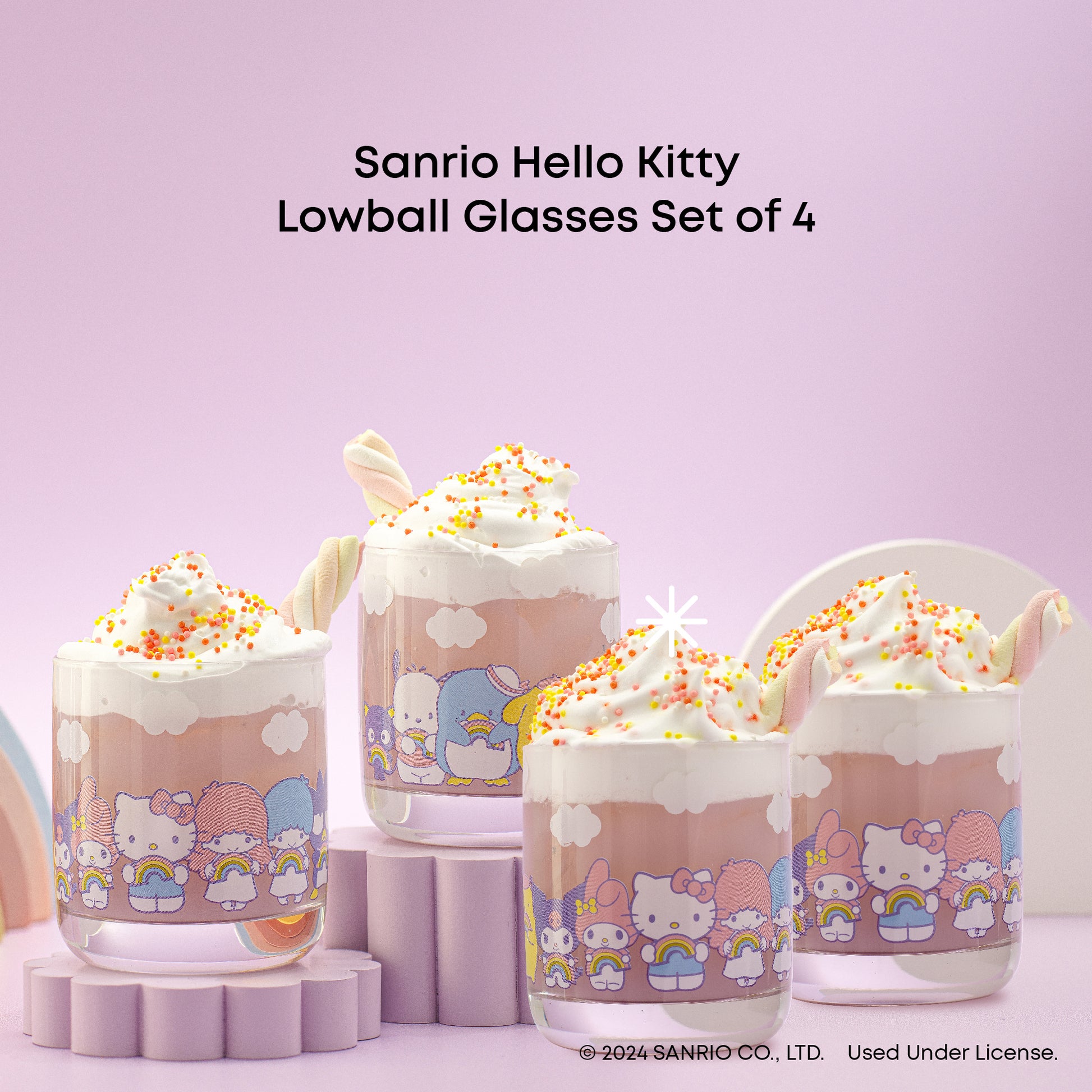 A set of four Hello Kitty themed short drinking glasses with a rainbow design, displayed against a pastel background.