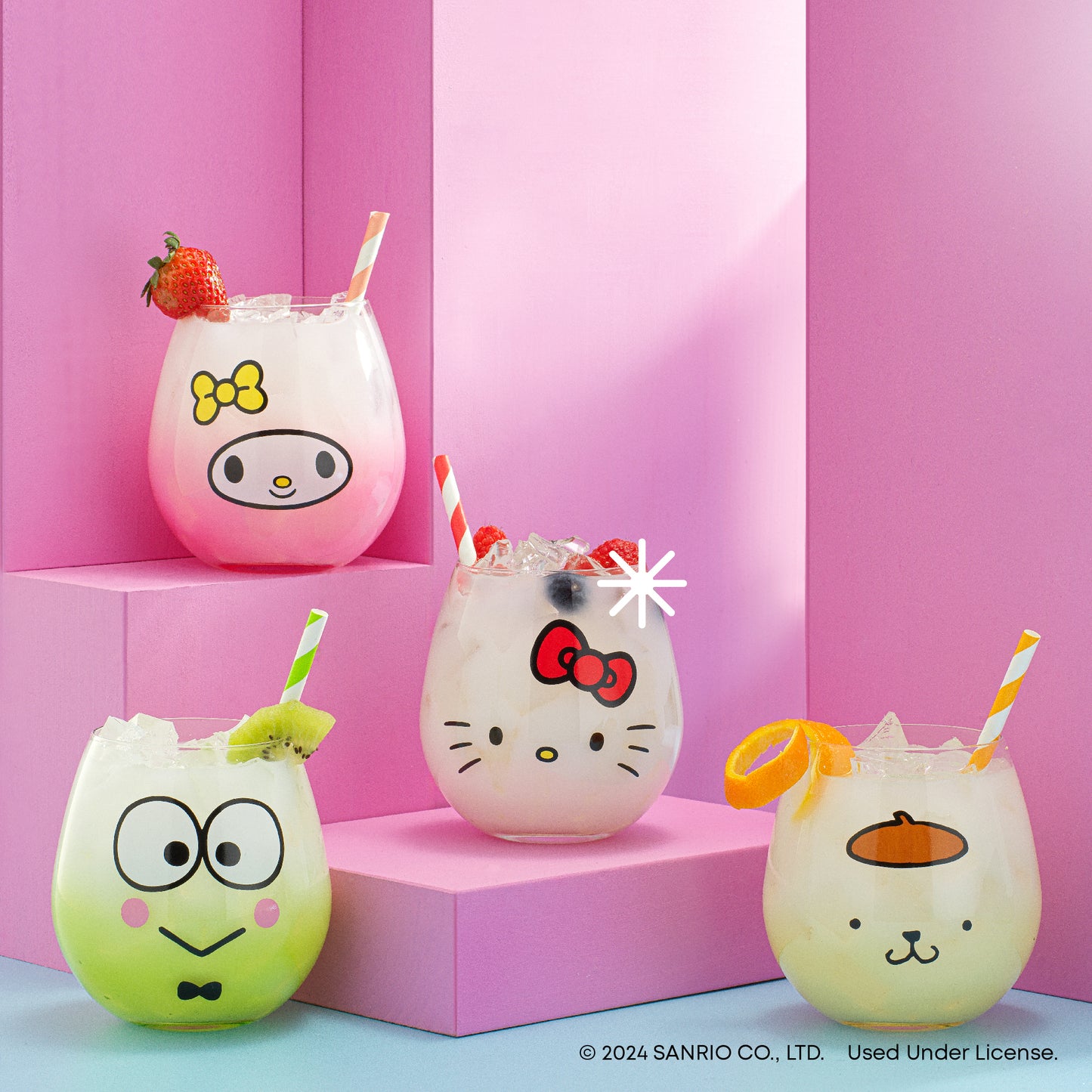 A set of four stemless drinking glasses, each decorated with an illustration of a Hello Kitty and Friends character - Hello Kitty, My Melody, Keroppi, and Pompompurin - presented against a pink backdrop.