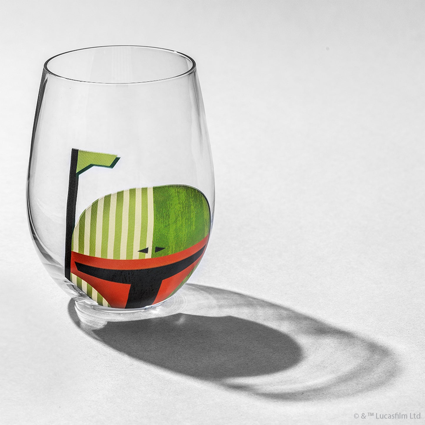 A stemless clear glass with Boba Fett helmet design against a white background.