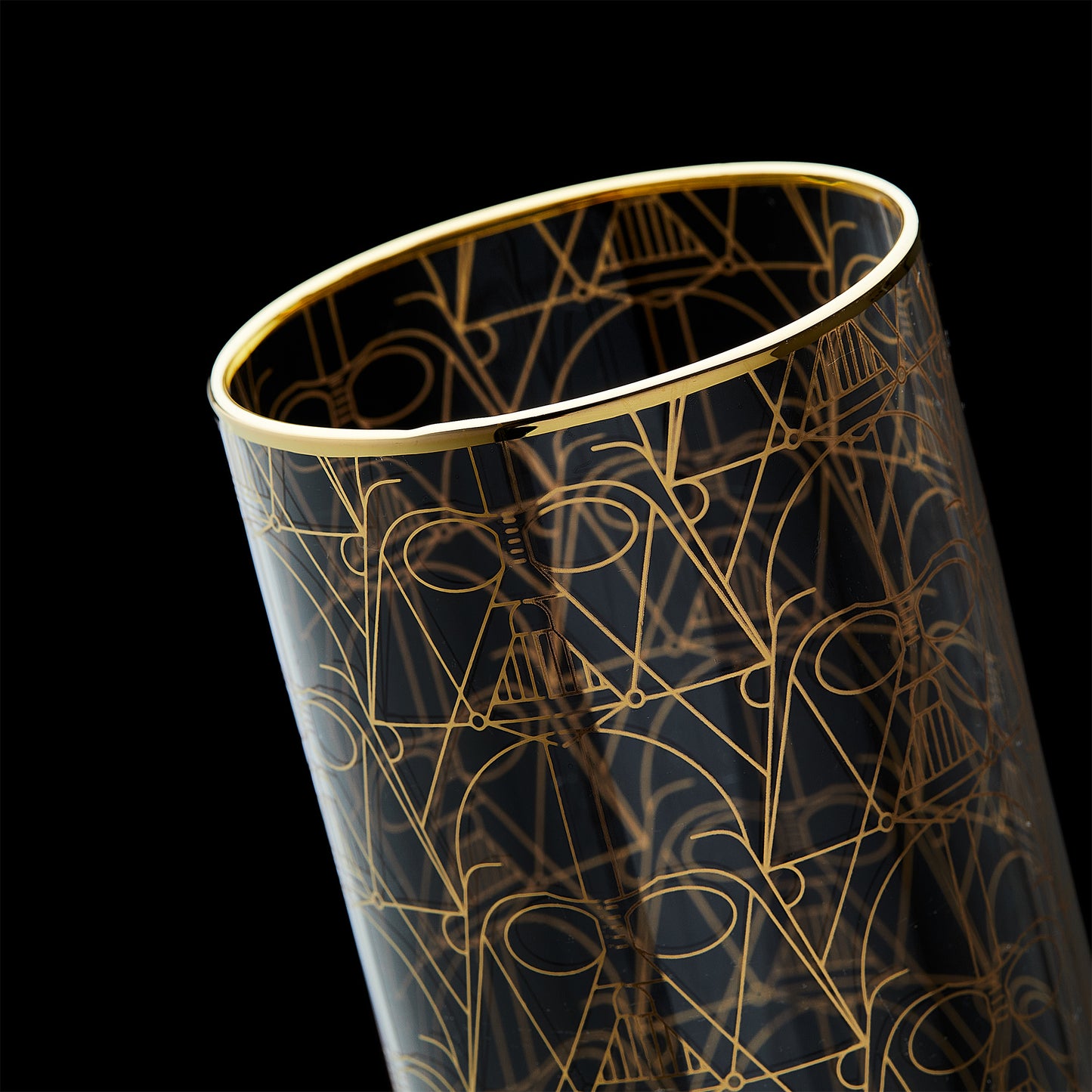 Close up image of the Darth Vader glass against a black background, highlighting the gold rims.