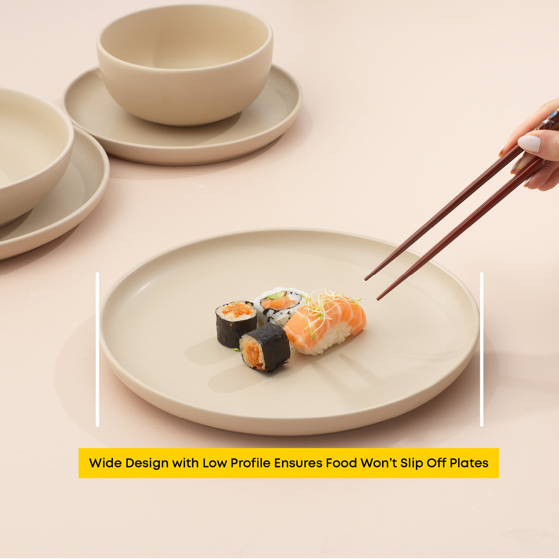 Sushi arranged on a dinner plate with a hand and chopsticks nearing to grab a piece, with text "wide design with low profile ensures food won't slip off plates."
