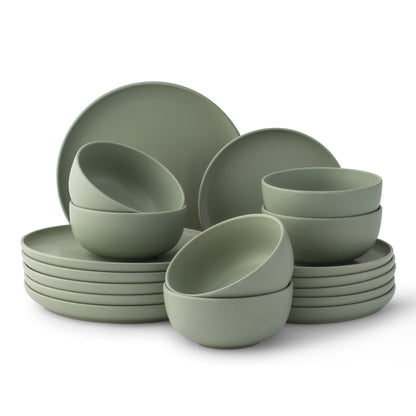 Set of green dinnerware including bowls and plates on a white background