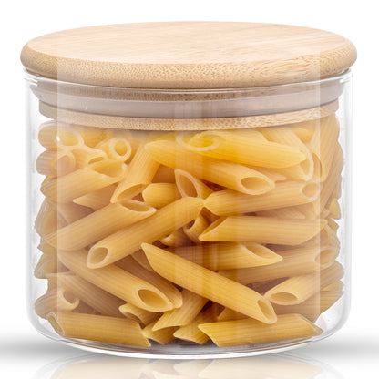 Storage jar with bamboo lid filled with penne pasta. 