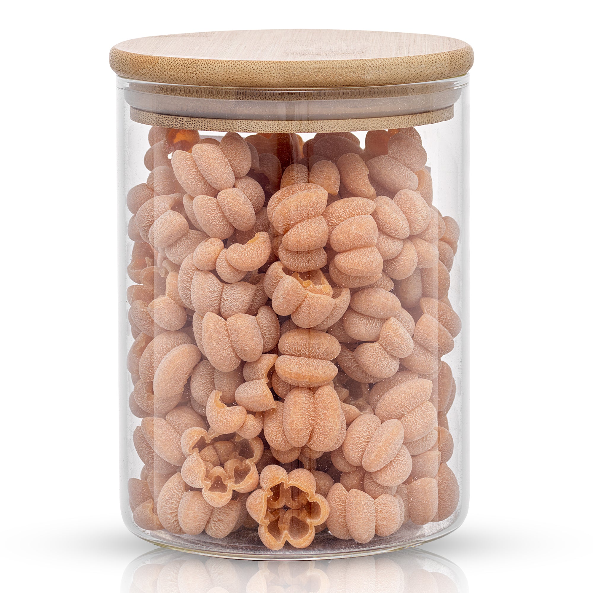 Storage jar with bamboo lid filled with pumpkin shaped pasta. 