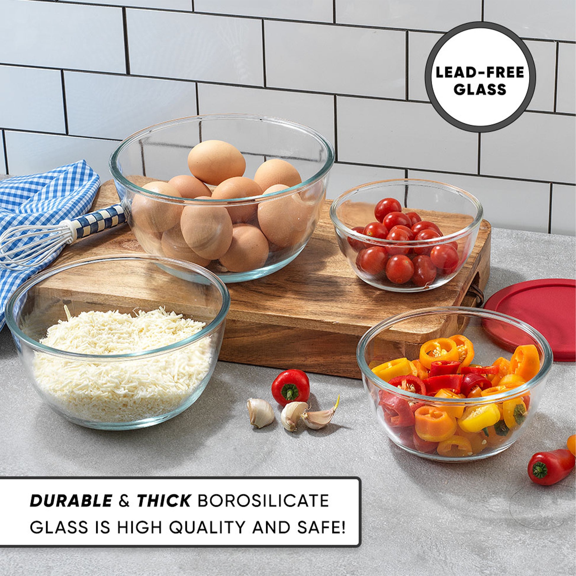 Bowls full with eggs, cheese, tomatoes, and peppers on a wooden board with text: durable and thick lead free glass.