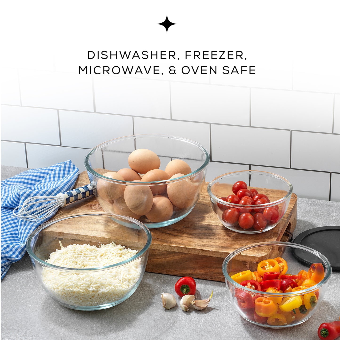 Three transparent glass bowls with lids sit on a wooden cutting board. The bowls are filled with colorful vegetables and eggs.