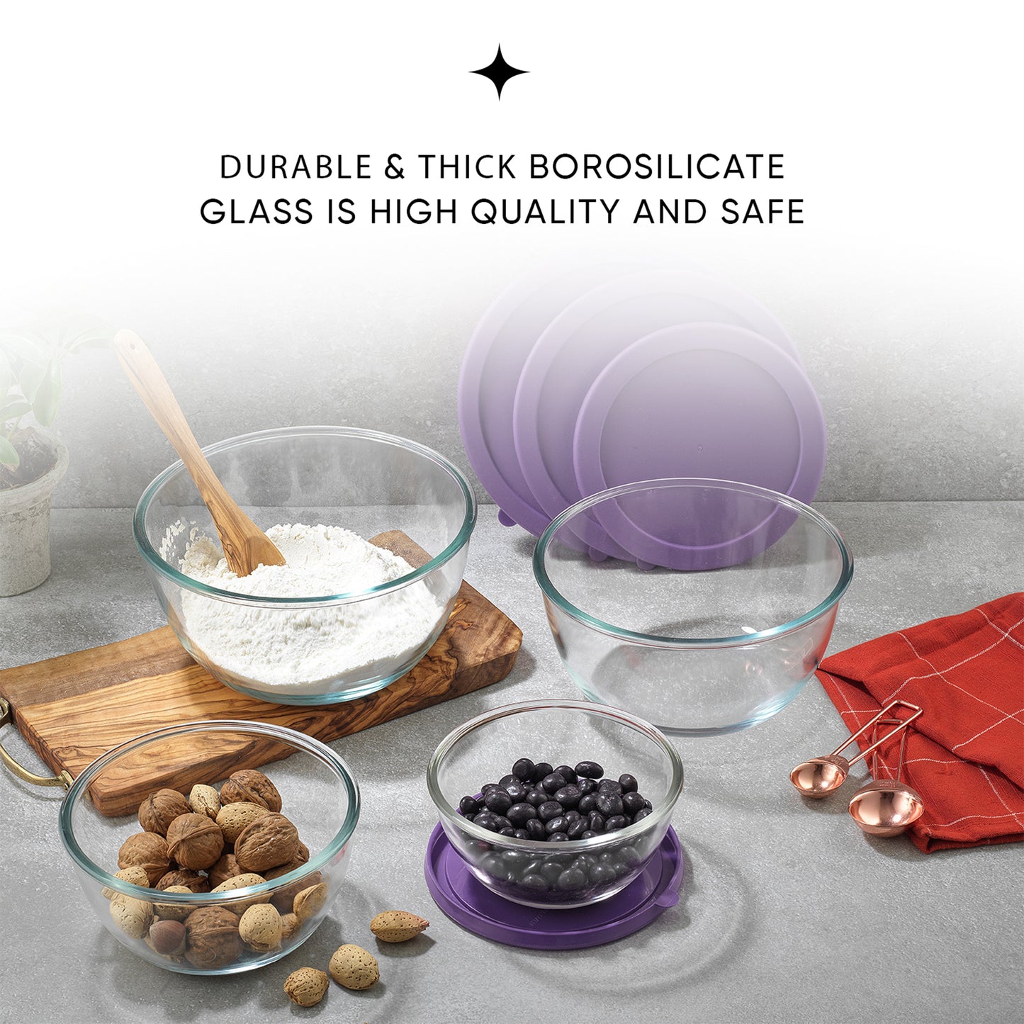 Four glass bowls filled with nuts and flour sit on a table. The bowls have purple lids next to them. Text on the image reads: "durable and thick borosilicate glass"