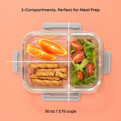 Glass meal prep container with 3 compartments filled with food on a pink background