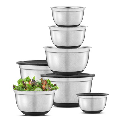 Set of stainless steel mixing bowls with black lids on a white background