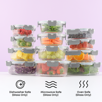 Set of clear food storage containers with fruits and vegetables on a white surface with a light purple background. Text call outs: dishwasher, microwave, and oven safe glass only.