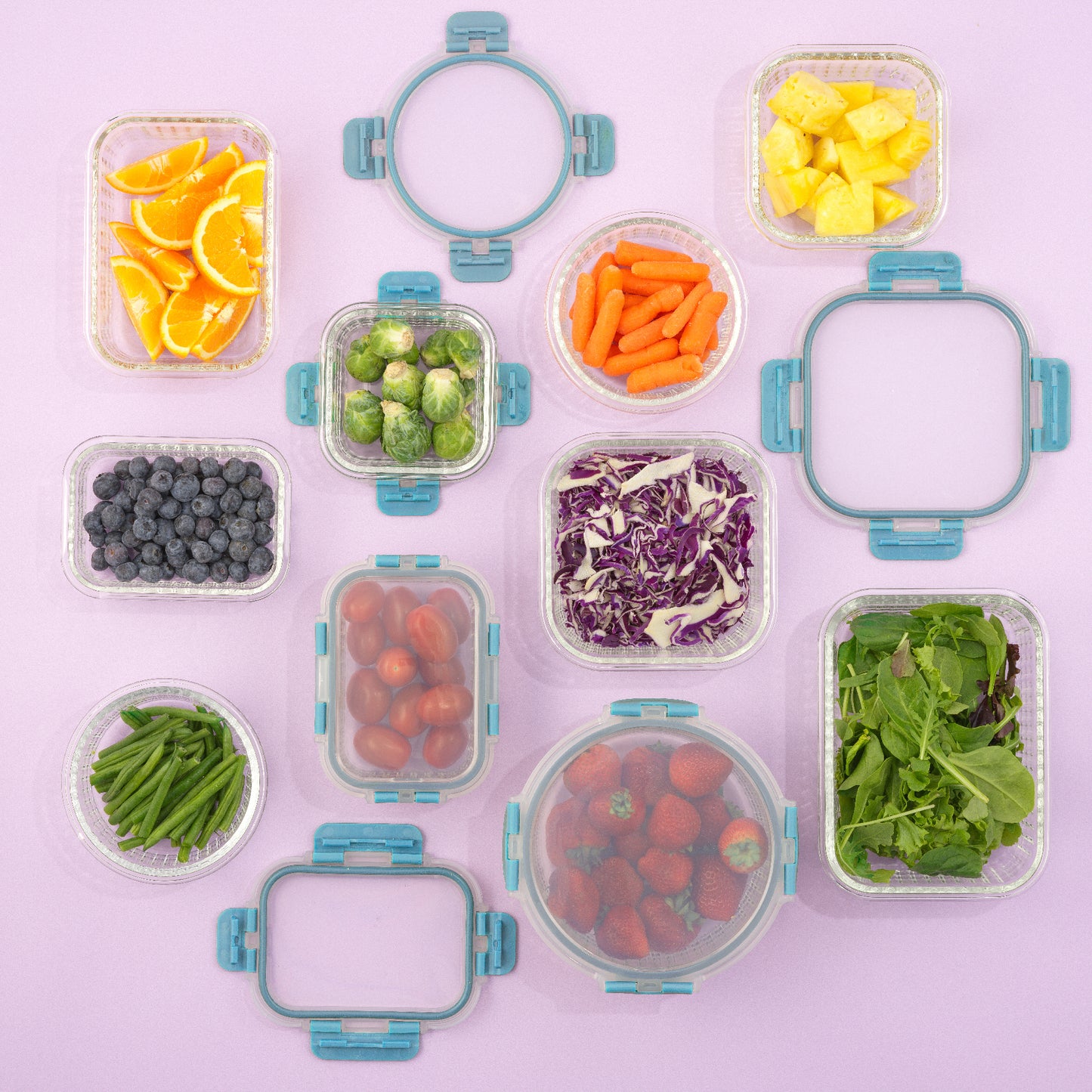 Assorted fruits and vegetables in clear containers on a light purple background
