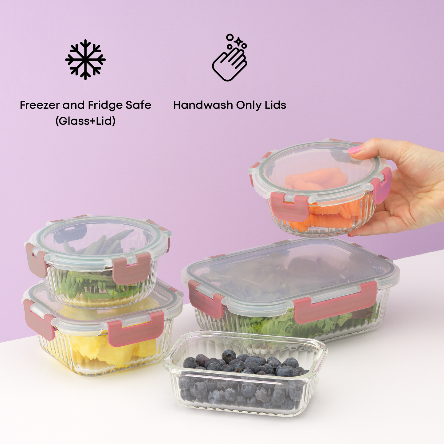 Set of glass food containers with pink lids on a white surface against a purple background. Text: handwash only lids, freezer and fridge safe.