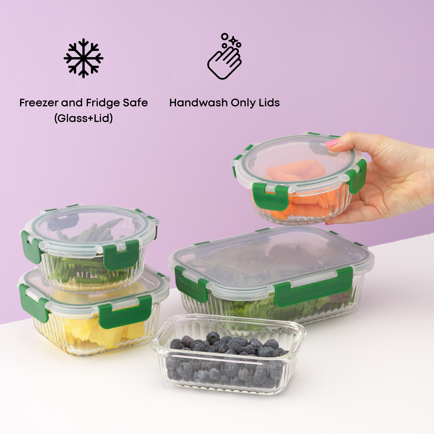 Set of glass food containers with green lids on a white surface against a purple background. Text: handwash only lids, fridge and freezer safe.