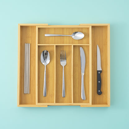 A drawer organized expanded with 6 slots, with straws, spoons, forks, and knives organized neatly in their slots