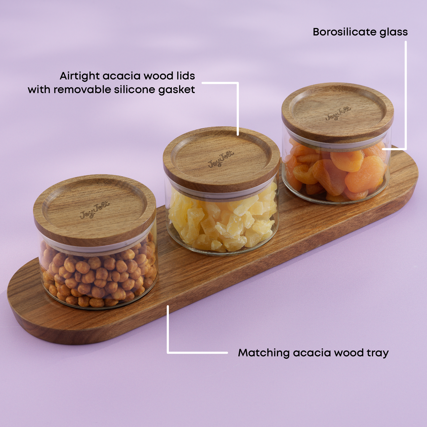 Three glass canisters with wooden lids on a matching wooden tray against a light purple background. with text "borosilicate glass, airtight acacia wood lids, matching acacia wood tray"