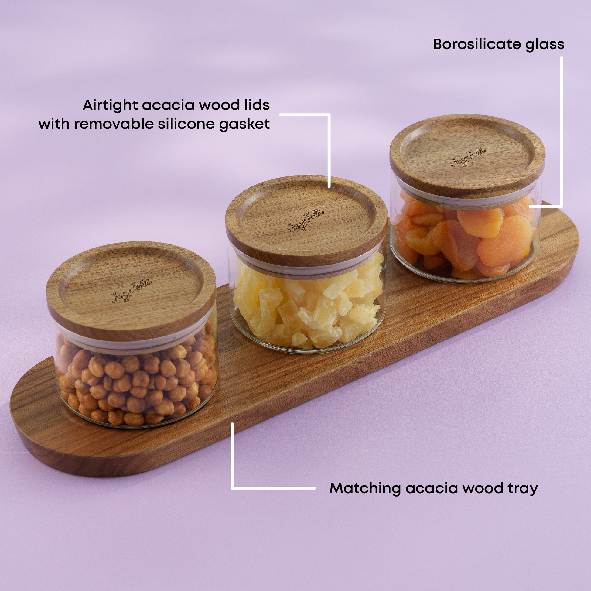 Three glass canisters with wooden lids on a matching wooden tray against a light purple background. with text "borosilicate glass, airtight acacia wood lids, matching acacia wood tray"