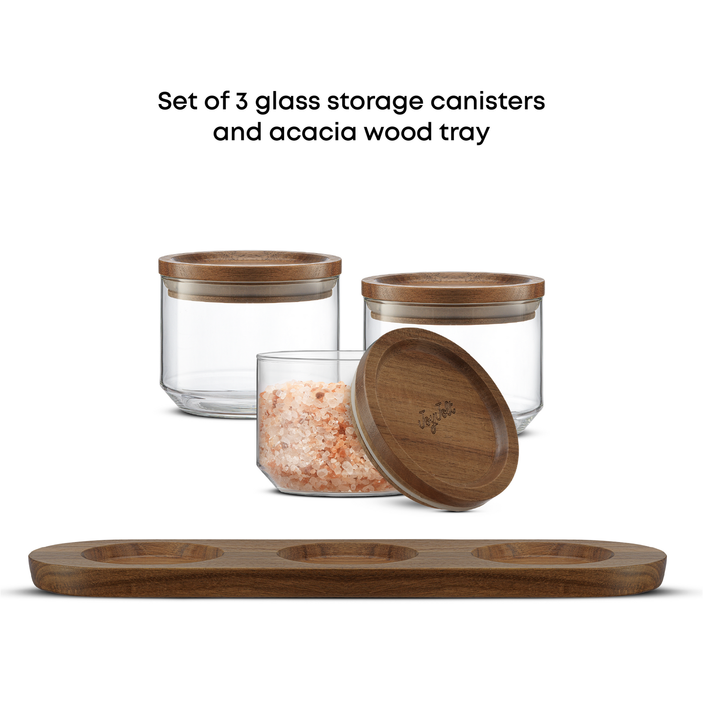 Set of three glass storage canisters with wooden lids and a wooden tray on a white background.