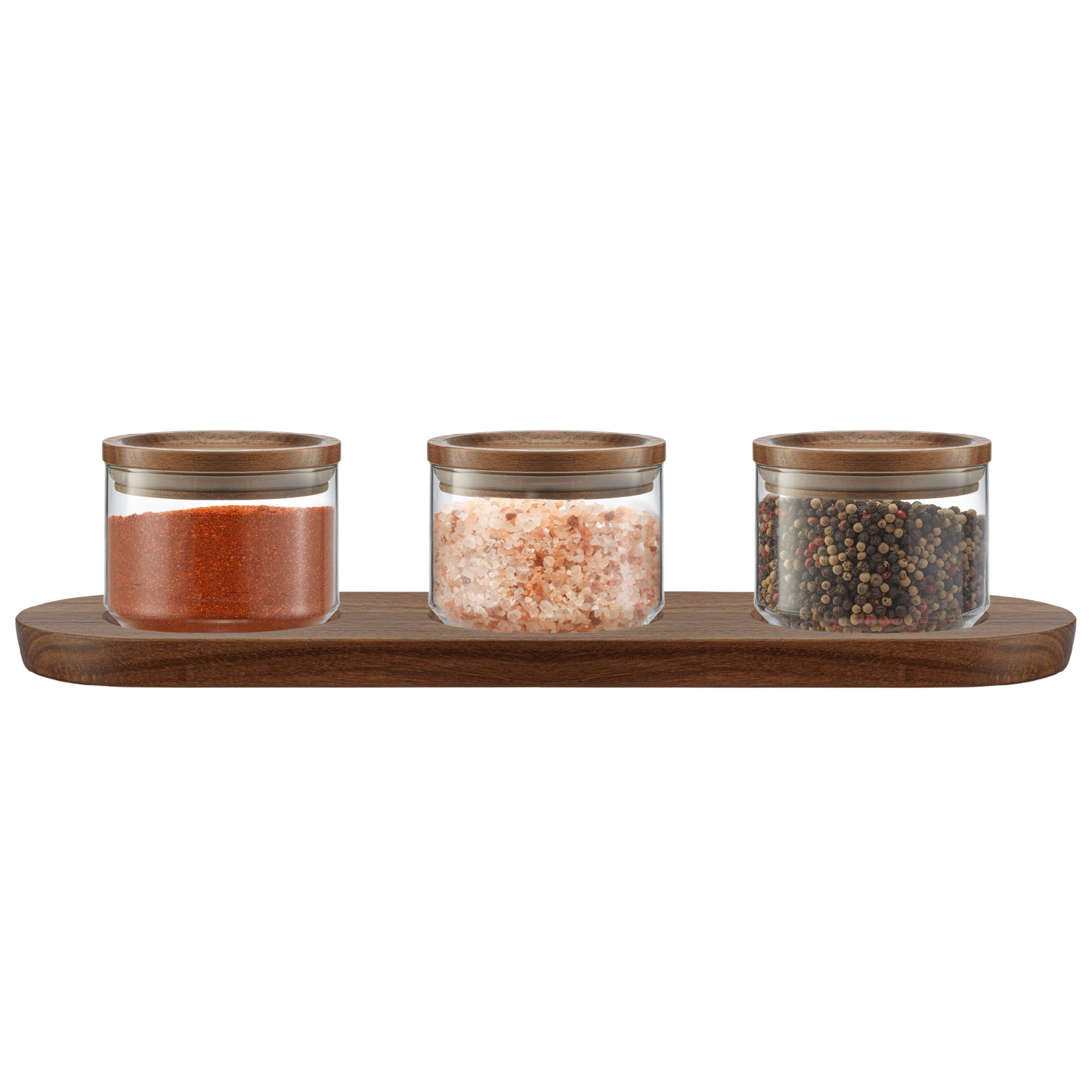 Set of three glass canisters with wooden lids on a wooden tray against a white background