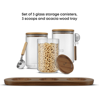 Set of 3 glass storage canisters with wooden lids, 3 scoops, and an acacia wood tray on a white background.