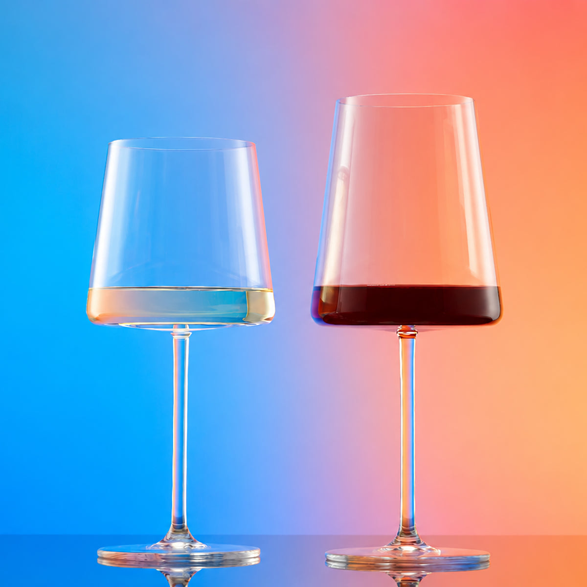 White and red wine glasses with modern tapered crystal bowls displayed side by side.